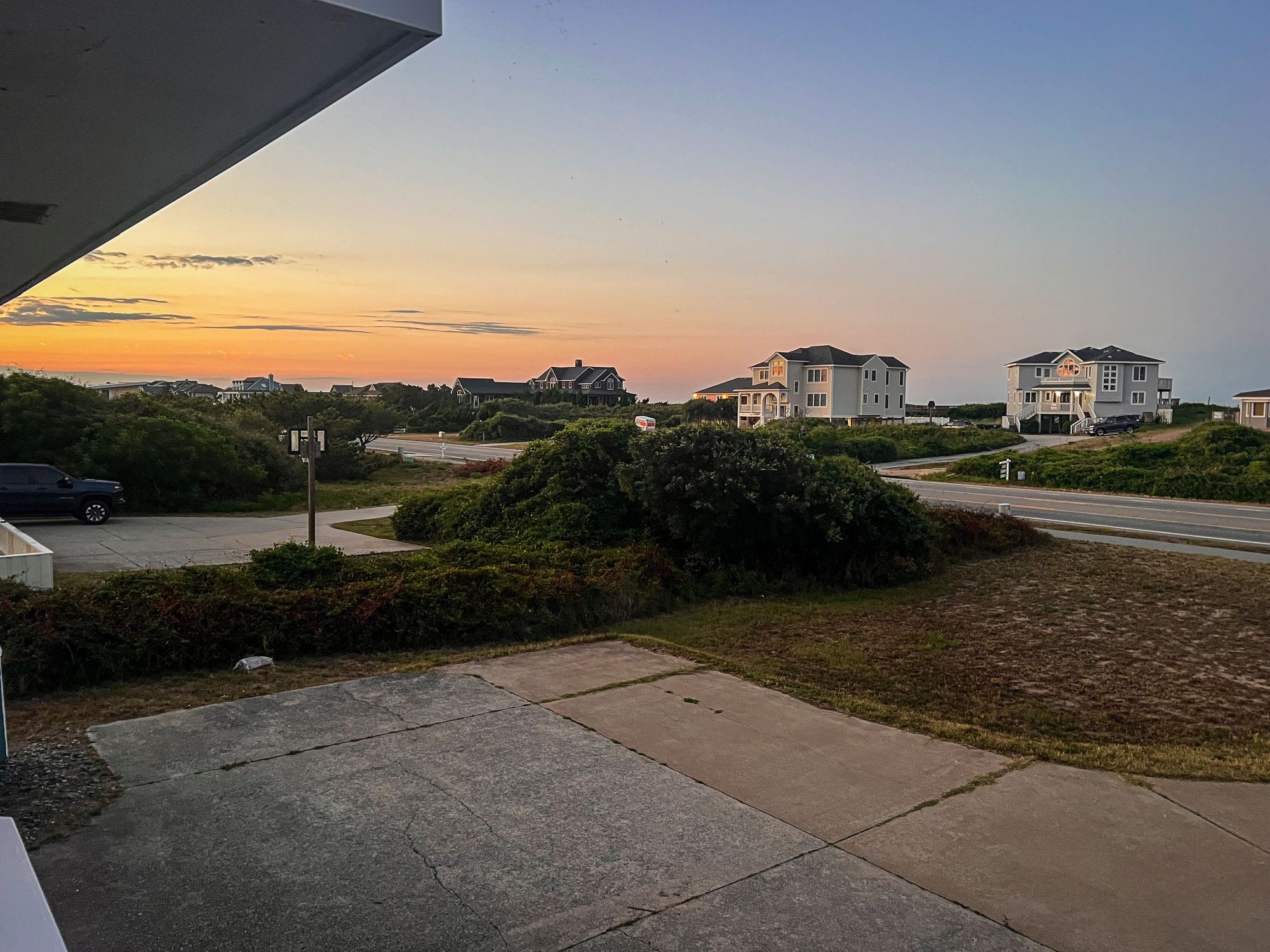 Sunset colors over beach houses along the road