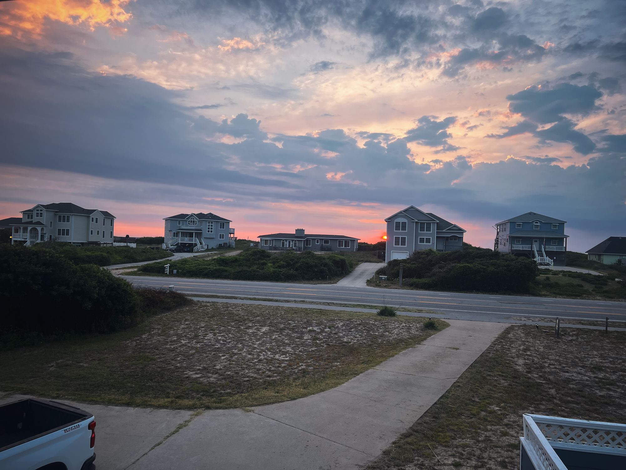 Dawn glow over beach cottages and dunes